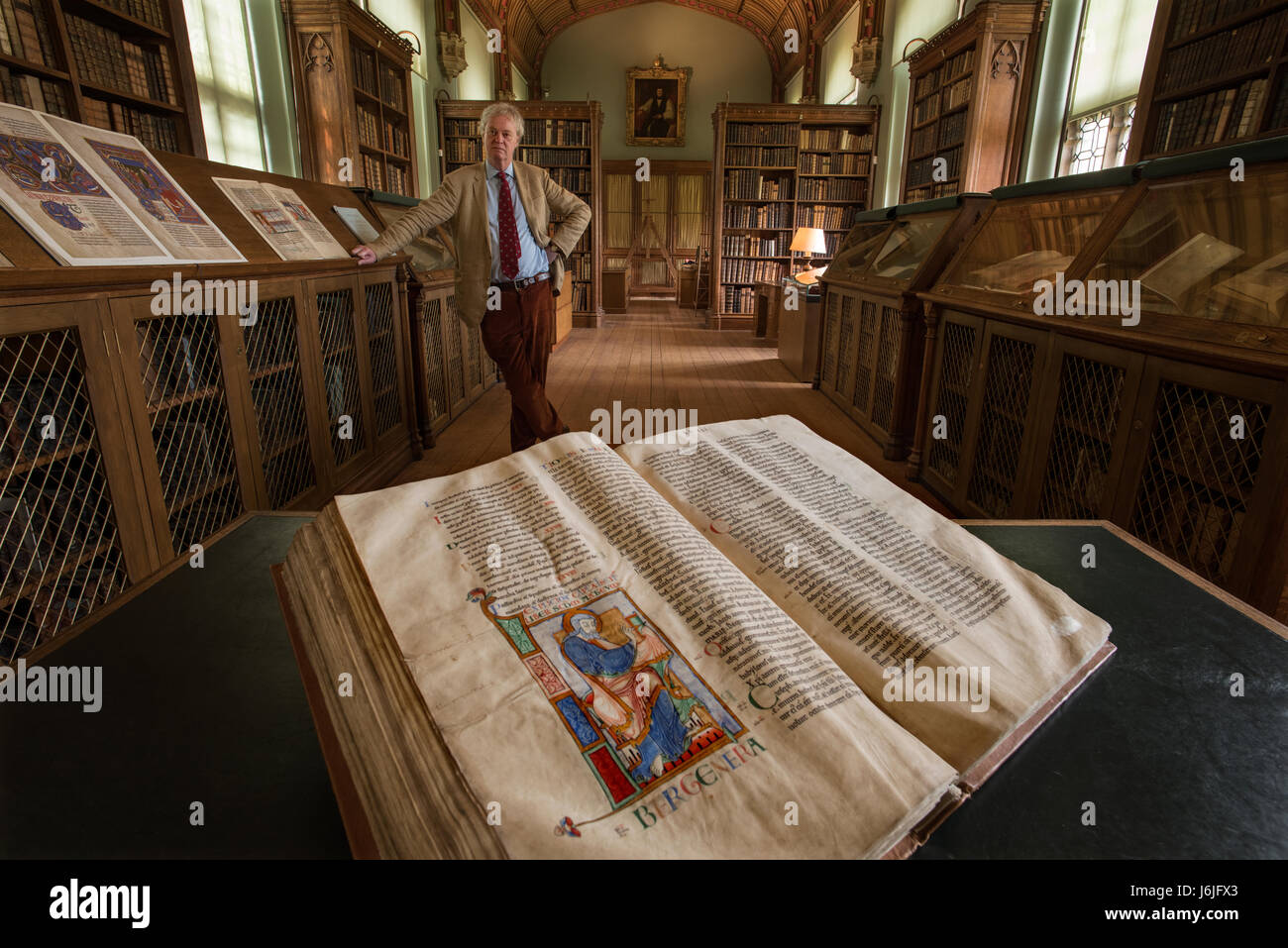 Parker Library Manuscripts, Corpus Christi College Cambridge, England, UK. 10 June 2016 Photo shows: Saint Matthew opening a book, initial from the illuminated manuscript Dover Bible, Canterbury,c 1150. Showing the Parker Librarian Dr. Christopher de Hamel in some of the photographs. Stock Photo