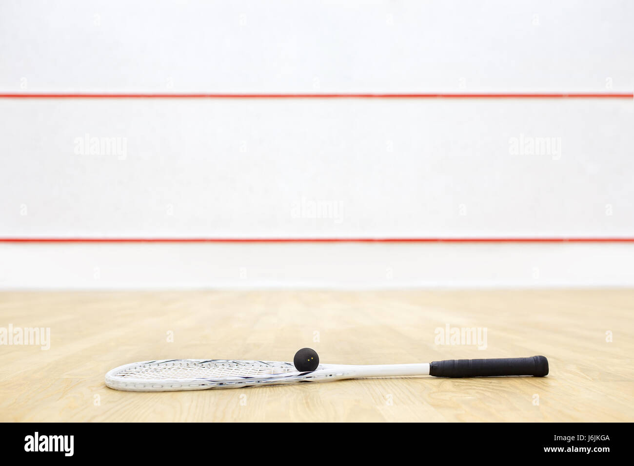 squash racket and ball on the floor. Racquetball equipment on the court
