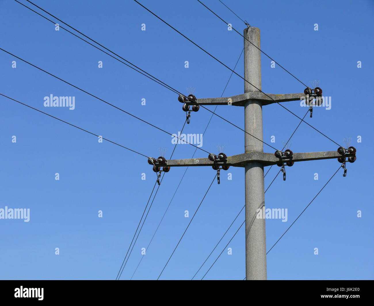 mast current mast high-tension line open-wire pole energy supply blue energy Stock Photo