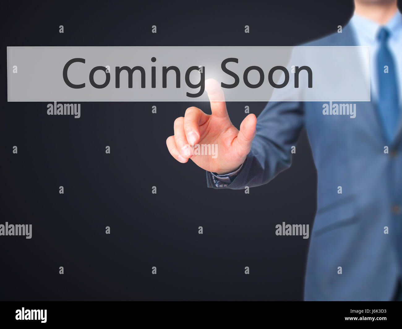 Coming Soon - Businessman click on virtual touchscreen. Business and IT concept. Stock Photo Stock Photo