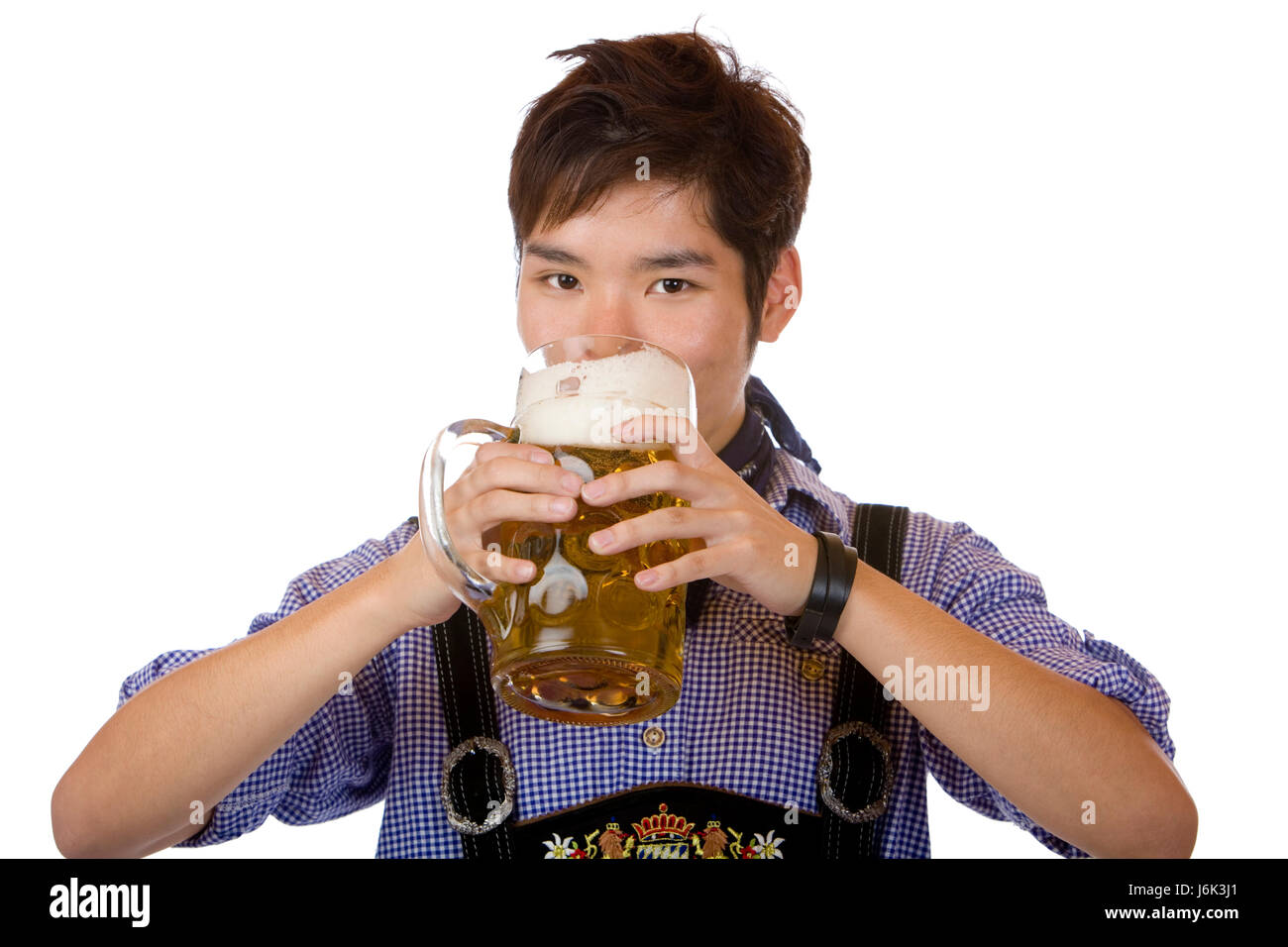 chinese with traditional bavarian tracht drinking out of oktoberfest beer stein Stock Photo