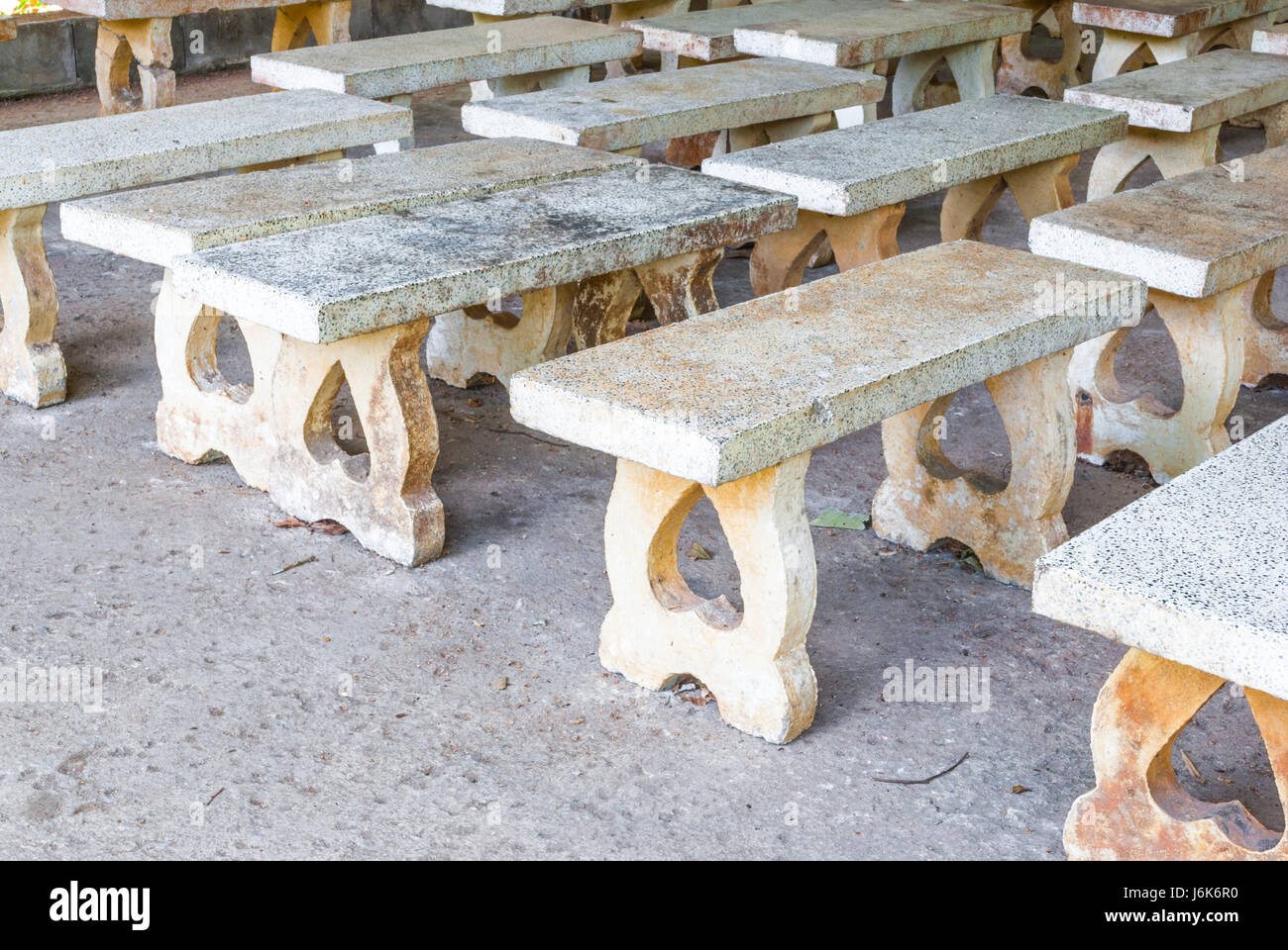 Closeup To Many Dirty Cement Benches In Quiet Place Stock Photo