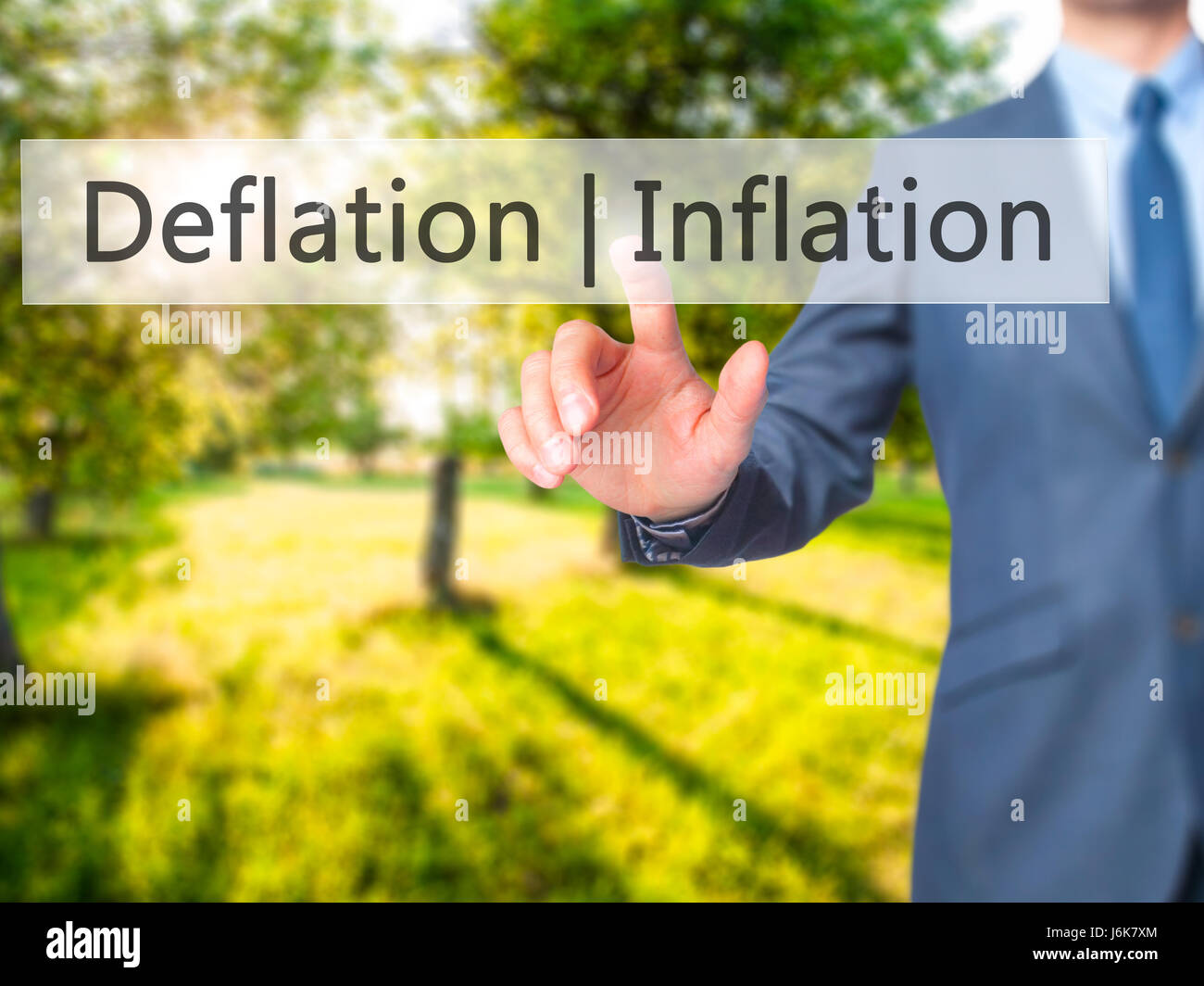 Deflation Inflation - Businessman hand pressing button on touch screen ...