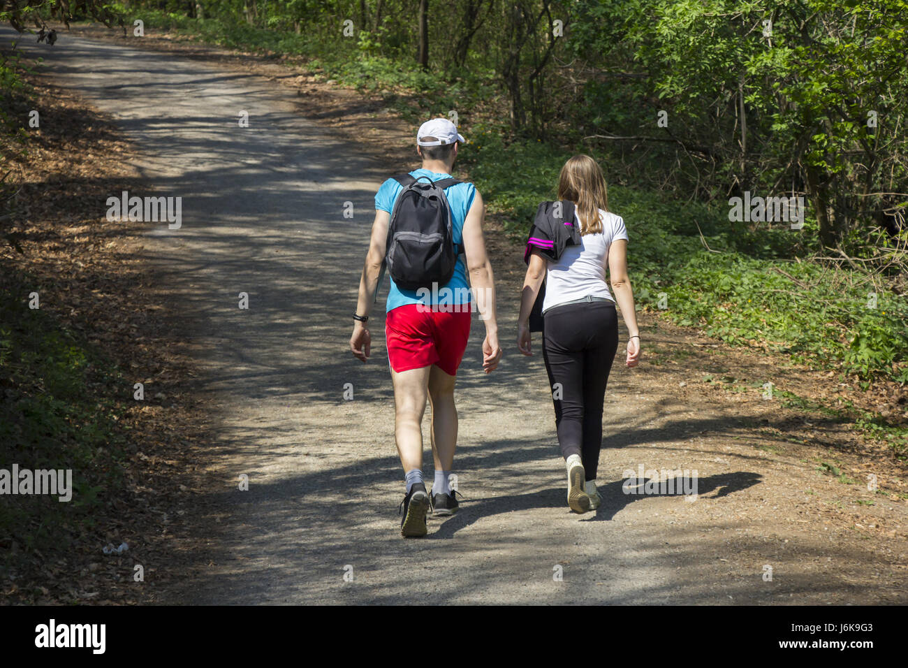 Young woman and a young man walking in the woods Stock Photo - Alamy