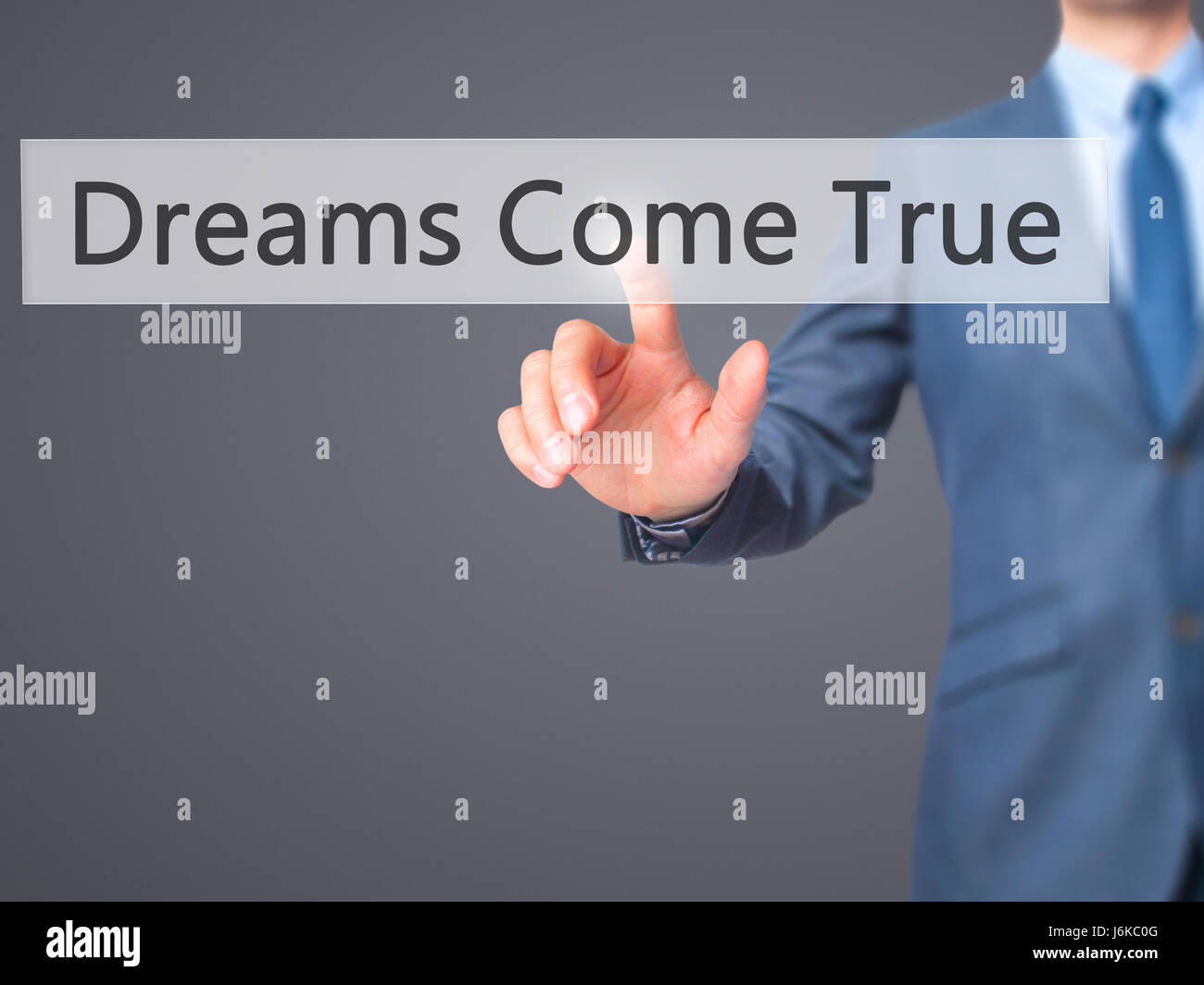Dreams Come True - Businessman hand pressing button on touch screen interface. Business, technology, internet concept. Stock Photo Stock Photo