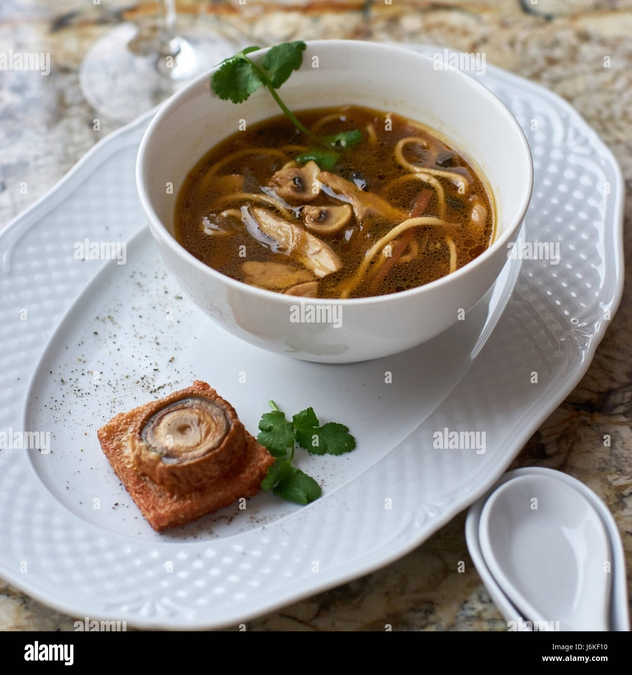 Mushroom soup with egg noodles Stock Photo - Alamy