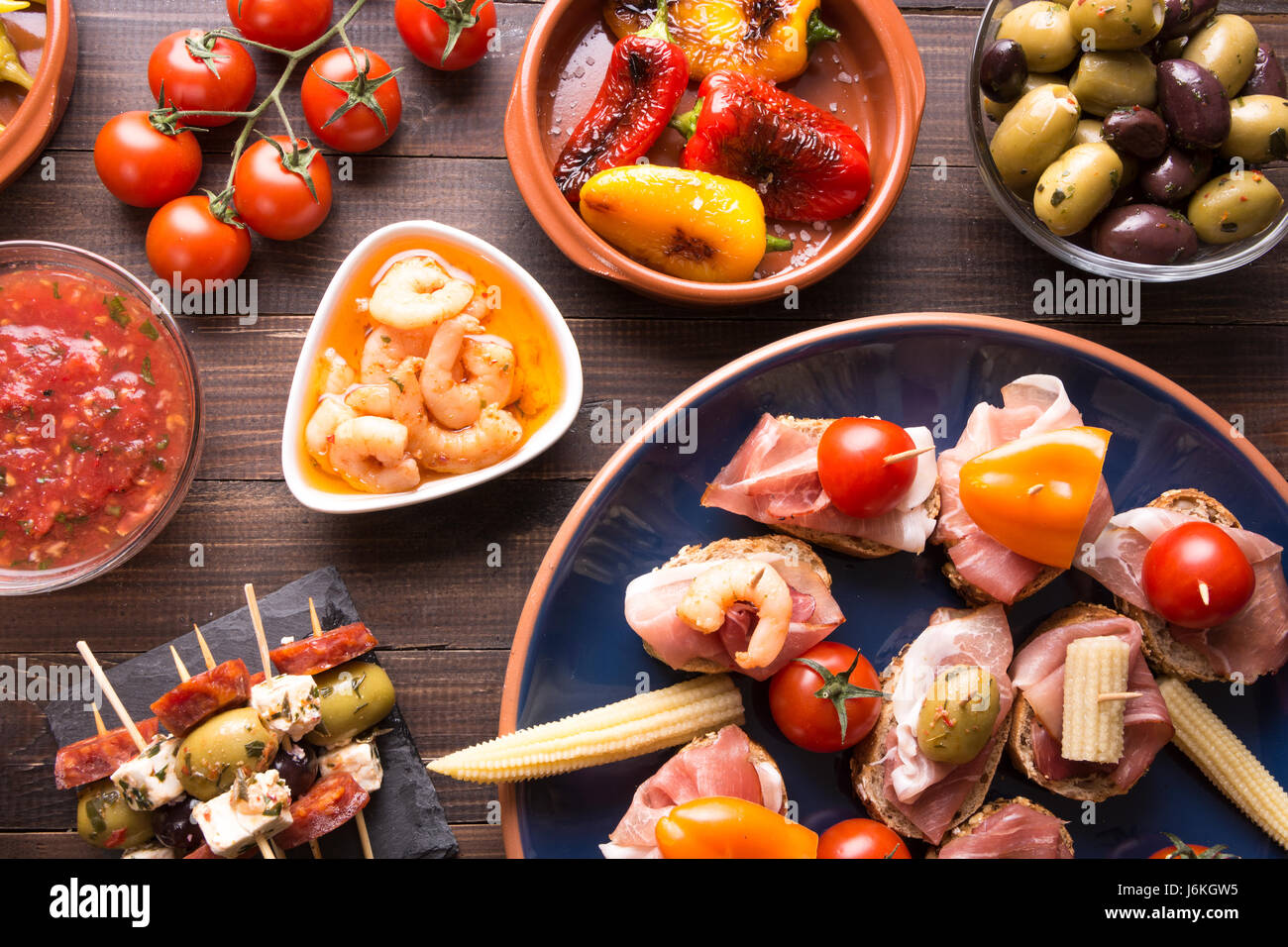 Mediterranean cuisine. Spanish tapas starters on wooden table. Top view ...