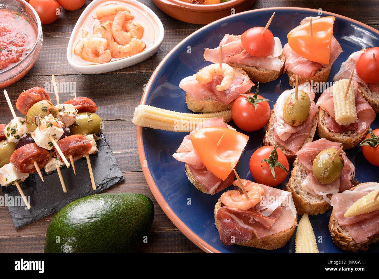 Mediterranean cuisine. Spanish tapas starters on wooden table. Top view ...