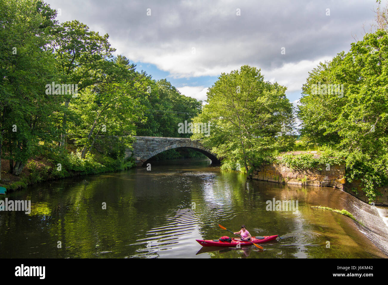 A woman kayaking on the Blackstone River in Uxbridge, MA Stock Photo