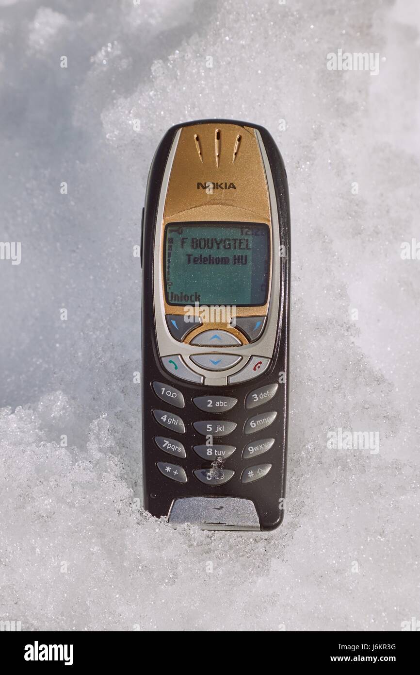 ALPE D'HUEZ, FRANCE - MARCH 14, 2017: Nokia 6310i cellphone laying in the snow. The 6310i was a very popular corporate phone after its introduction in Stock Photo
