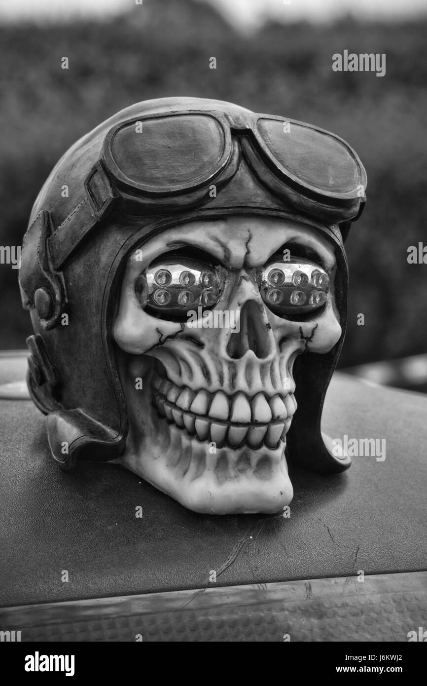 Black and white human skull in a helmet and redo goggles Stock Photo