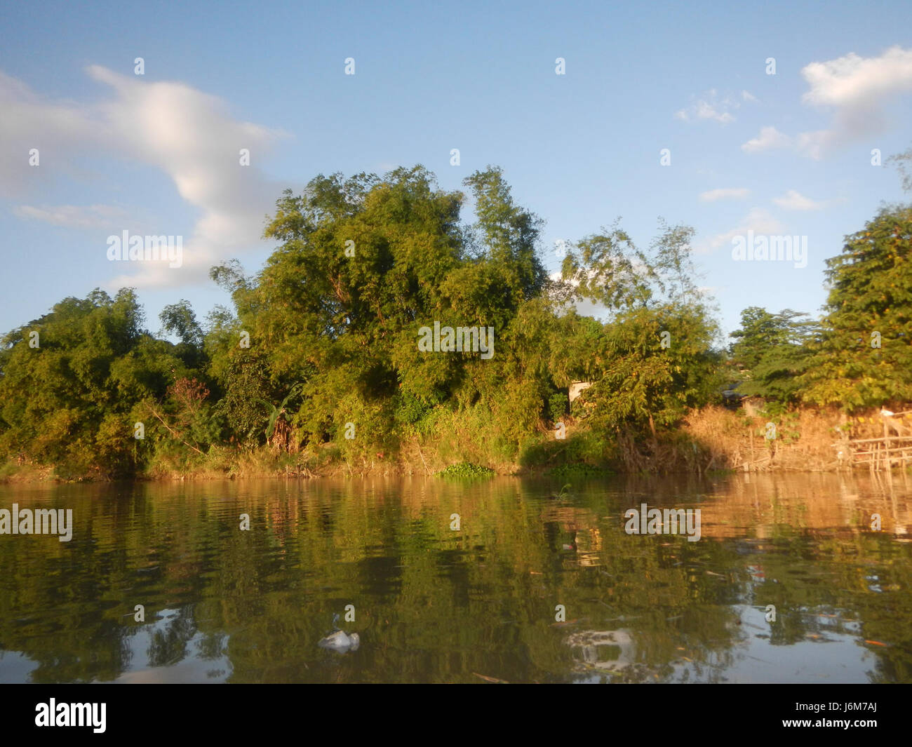 The riverbanks of Cansinala in Apalit, Pampanga, Philippines, are a ...