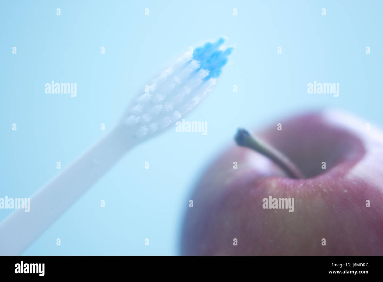 Dental toothbrush to clean teeth and fresh red apple for healthy eating ...