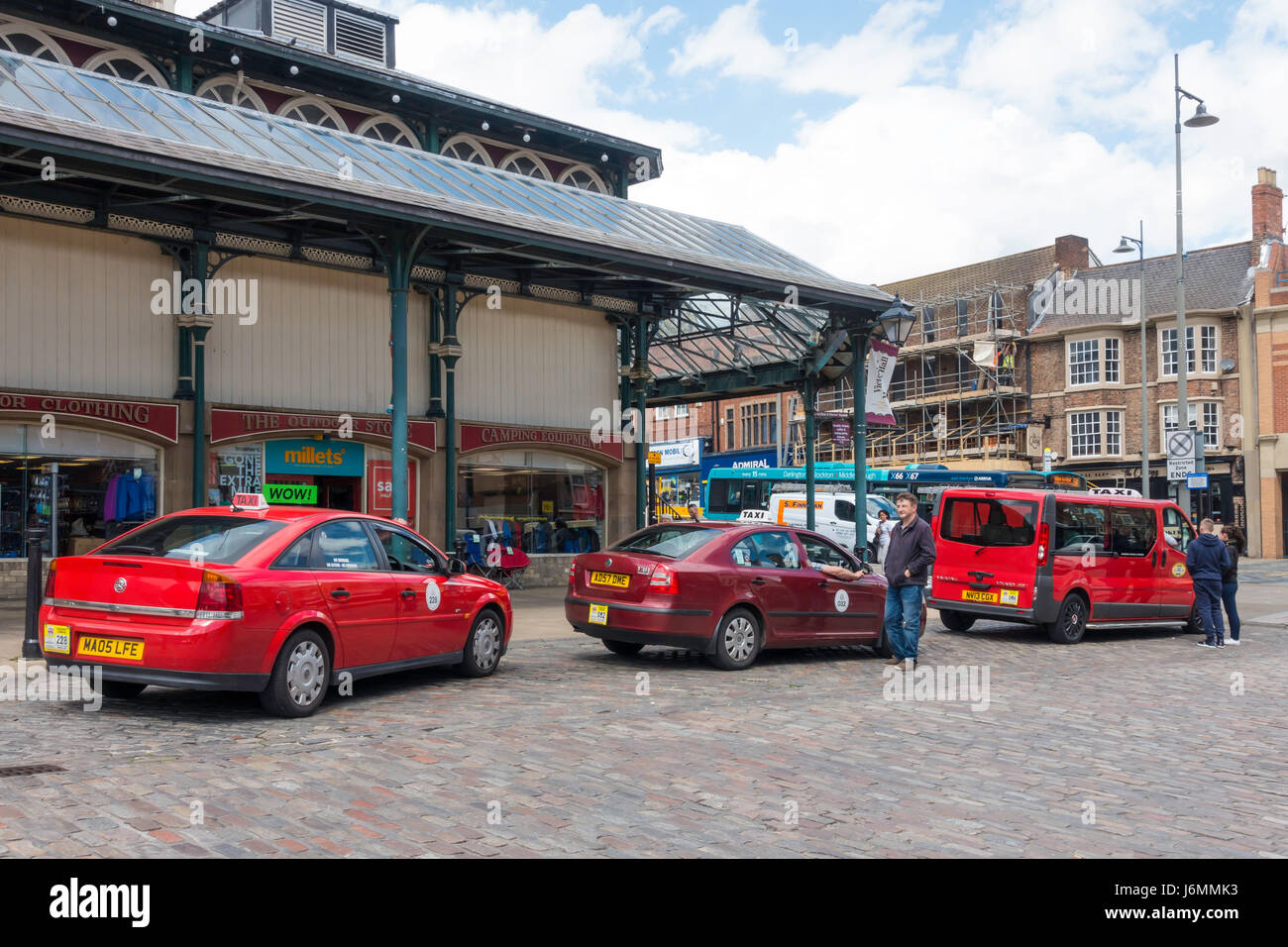 Taxi rank with red taxis waiting in the Market Square in Darlington Co. Durham Stock Photo