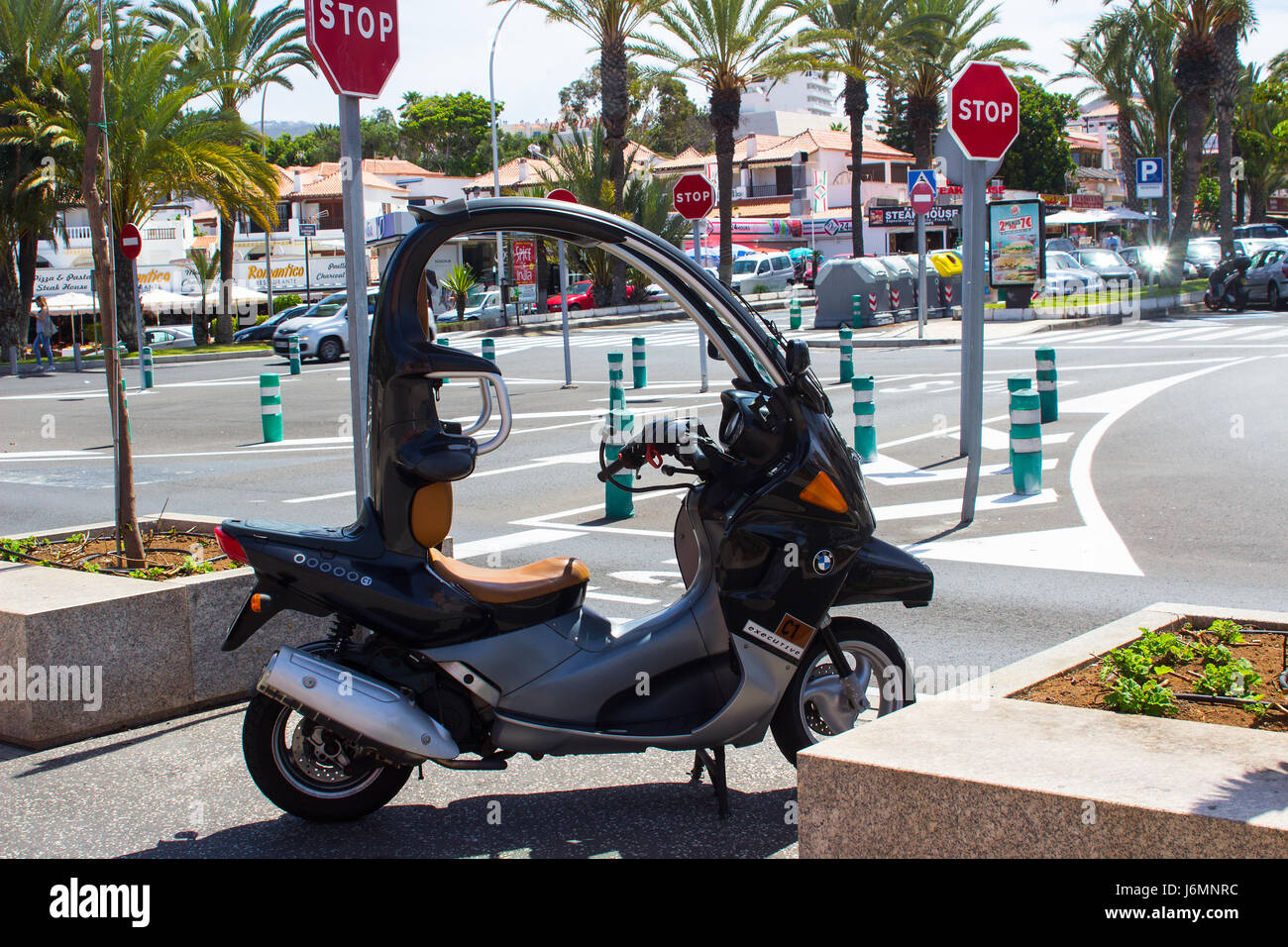 A silver covered B.M.W motor scooter parked on the street in Playa Las  Americas in the Canary island of Teneriffe Stock Photo - Alamy
