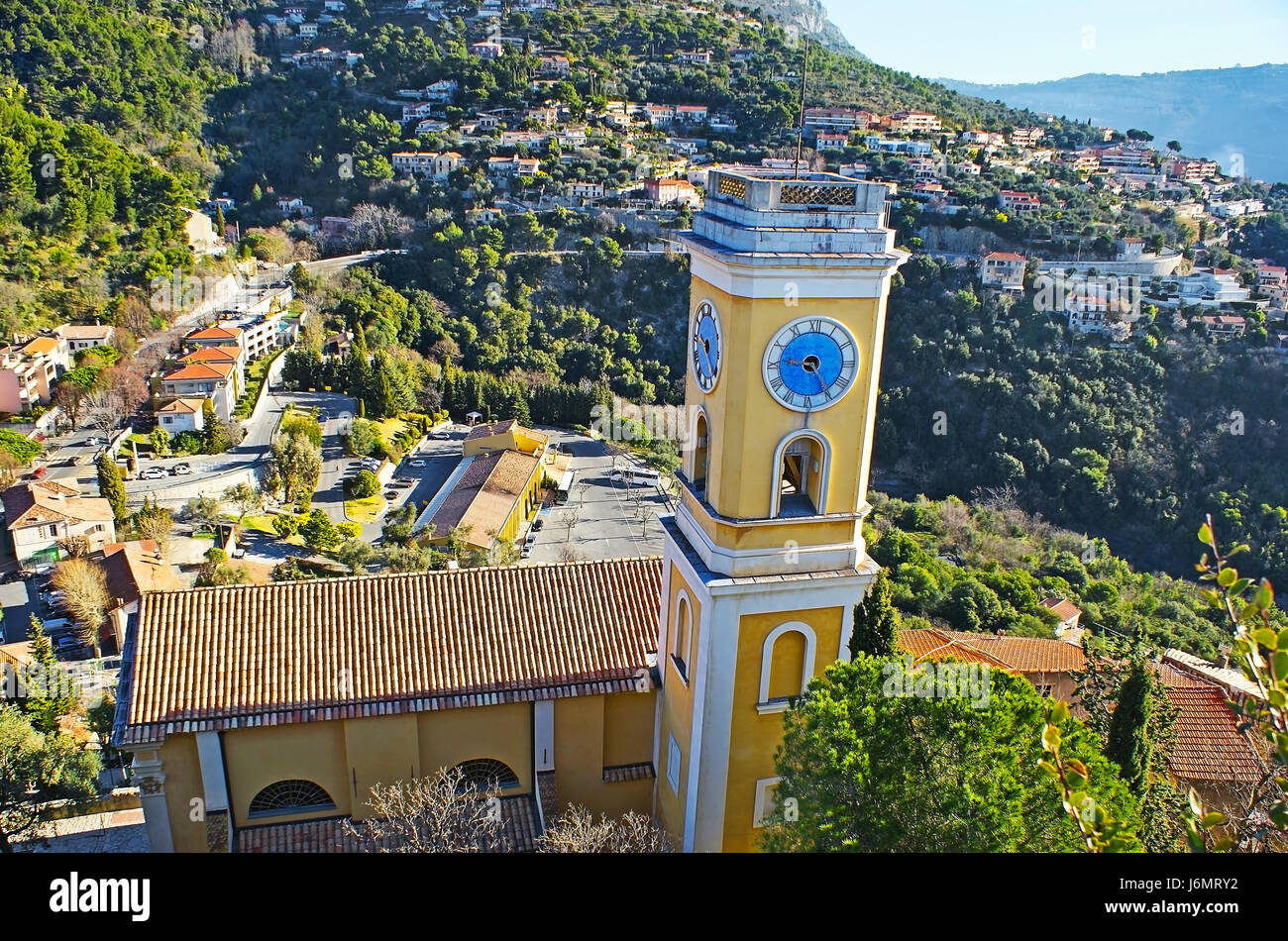 The clock tower of the Church of Our Lady of the Assumption, from the hilltop of Eze village, France. Stock Photo