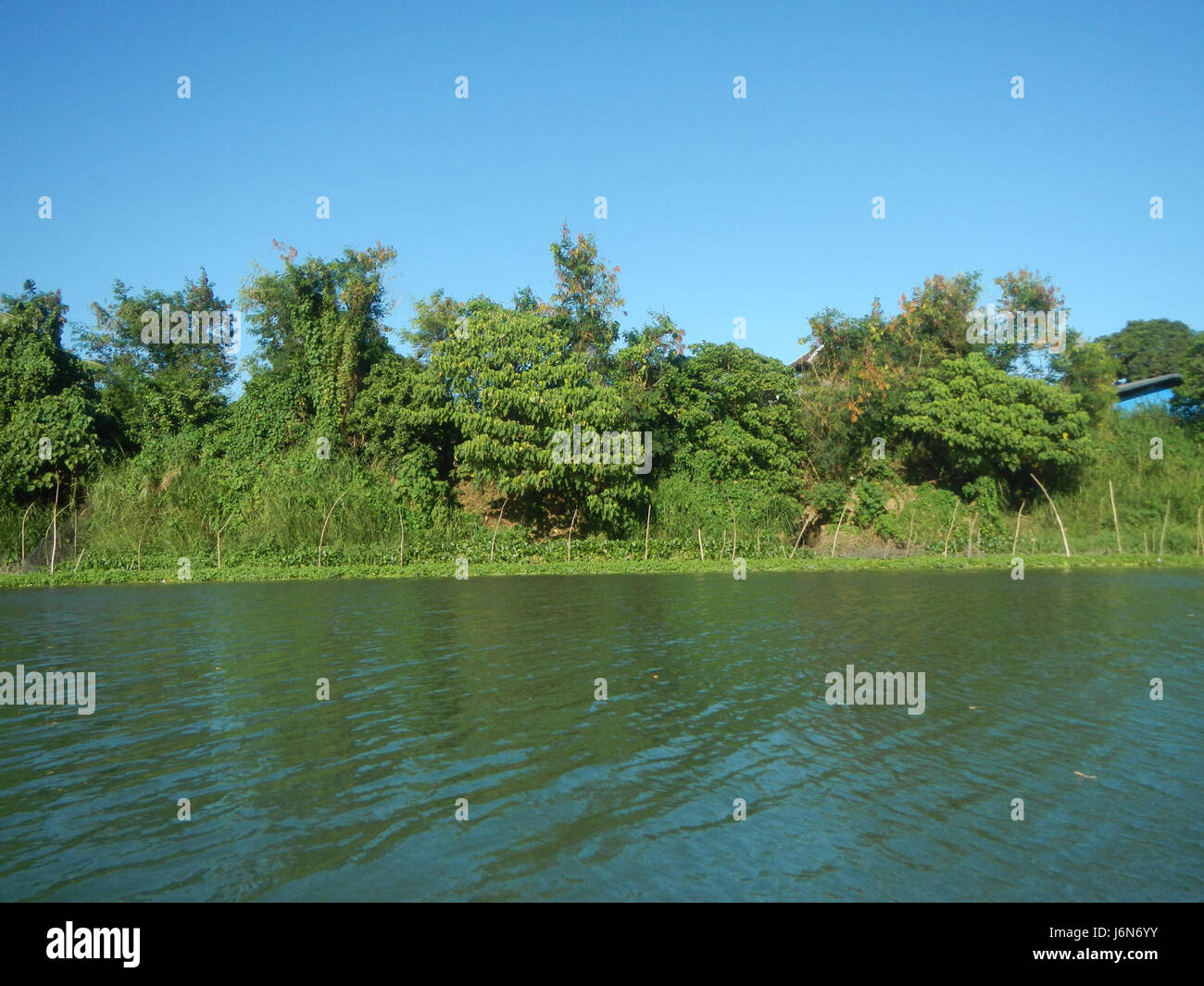 This image shows the construction of a riprap along the riverbanks of ...