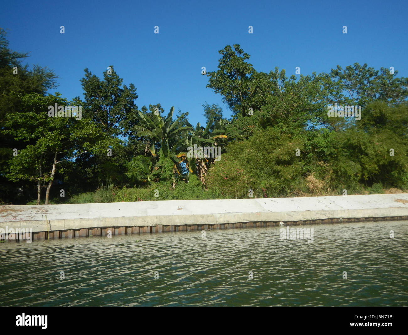 This image focuses on the riprap construction along the riverbanks of ...