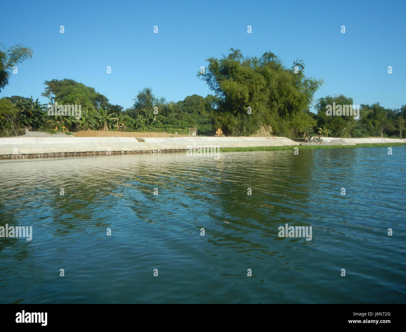 This image shows the construction of a riprap along the riverbanks of ...