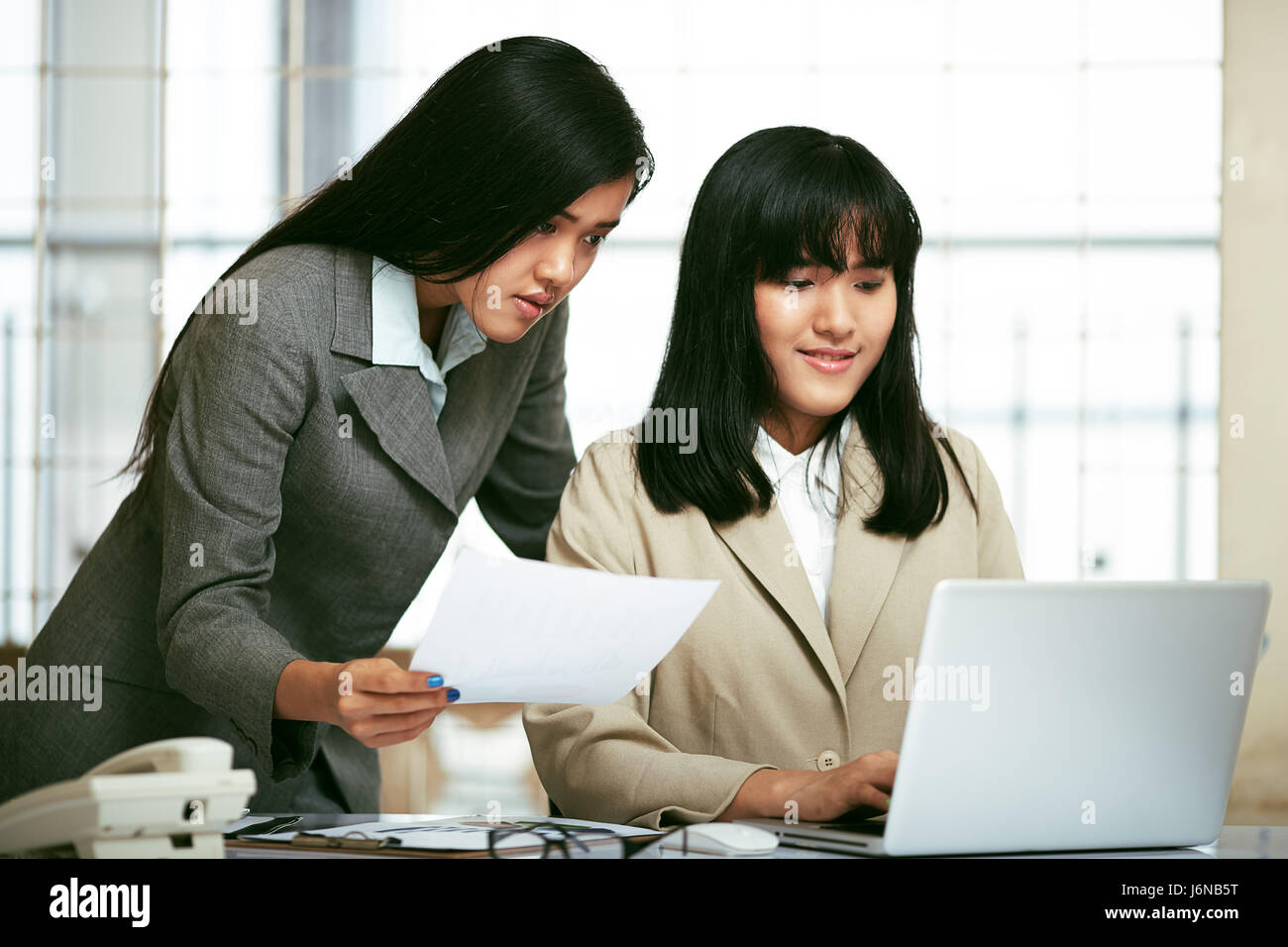 two office staffs working and discussing in office Stock Photo Alamy