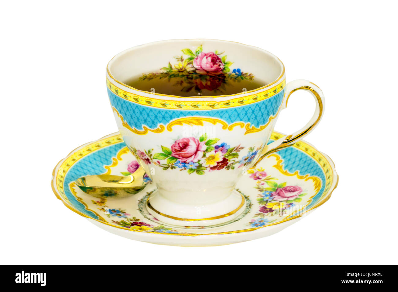 Vintage fine china tea cup and saucer with tea isolated on white. Stock Photo
