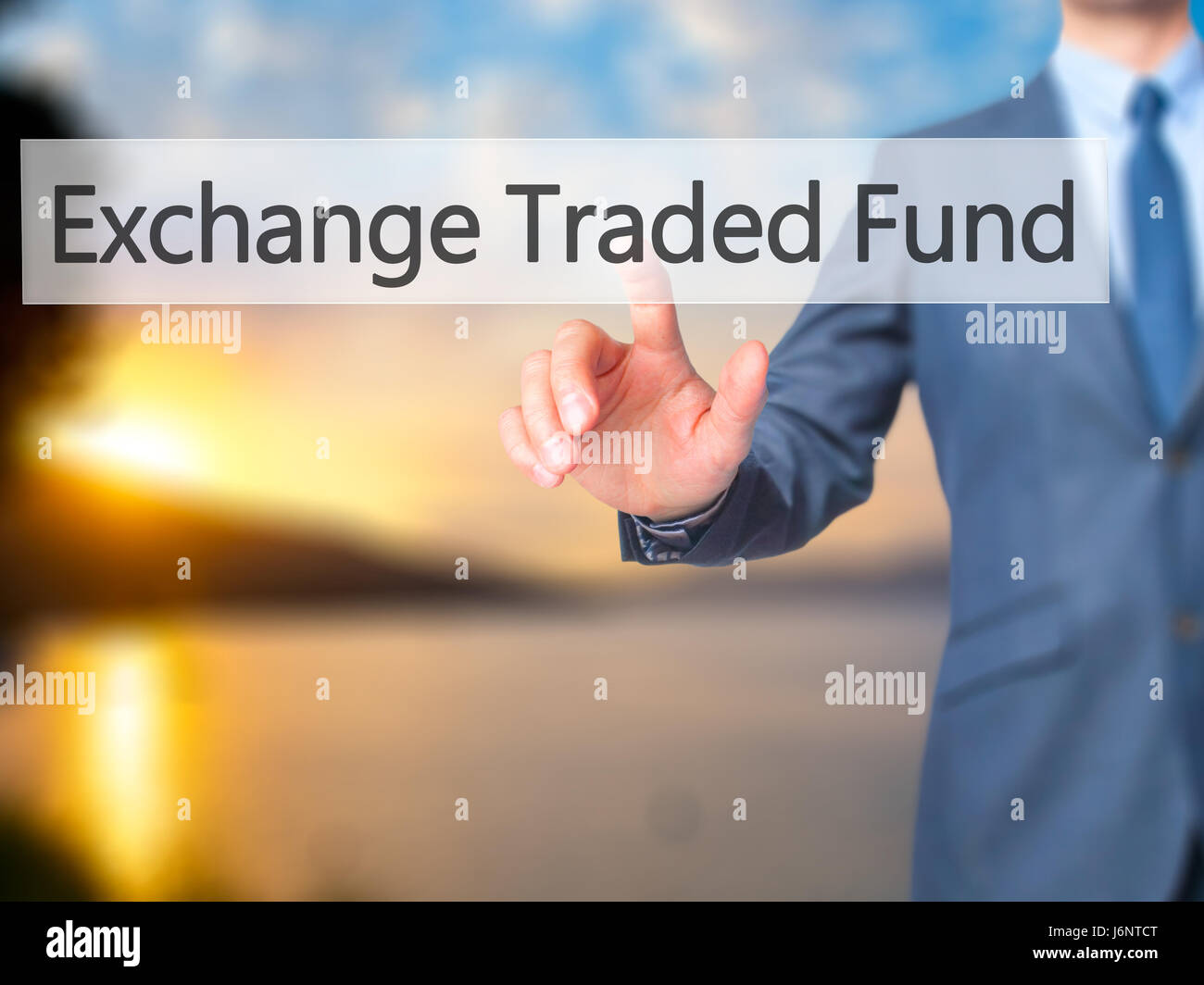 Exchange Traded Fund - Businessman hand pressing button on touch screen interface. Business, technology, internet concept. Stock Photo Stock Photo