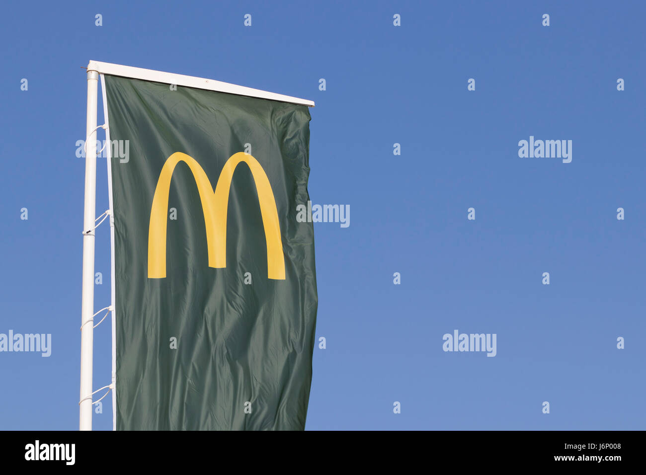 McDonalds food corporation logo in a green flag. Stock Photo