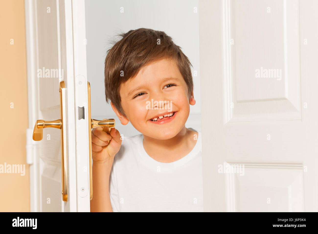 Closeup portrait of happy Caucasian kid boy looking through the