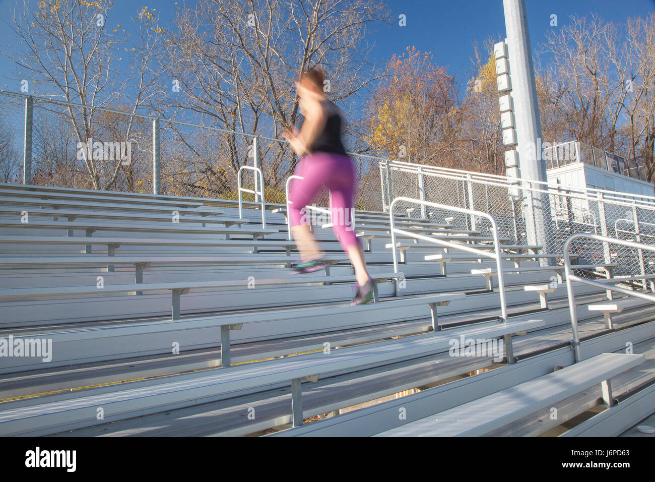 Athletic woman climbing bleachers Stock Photo Alamy