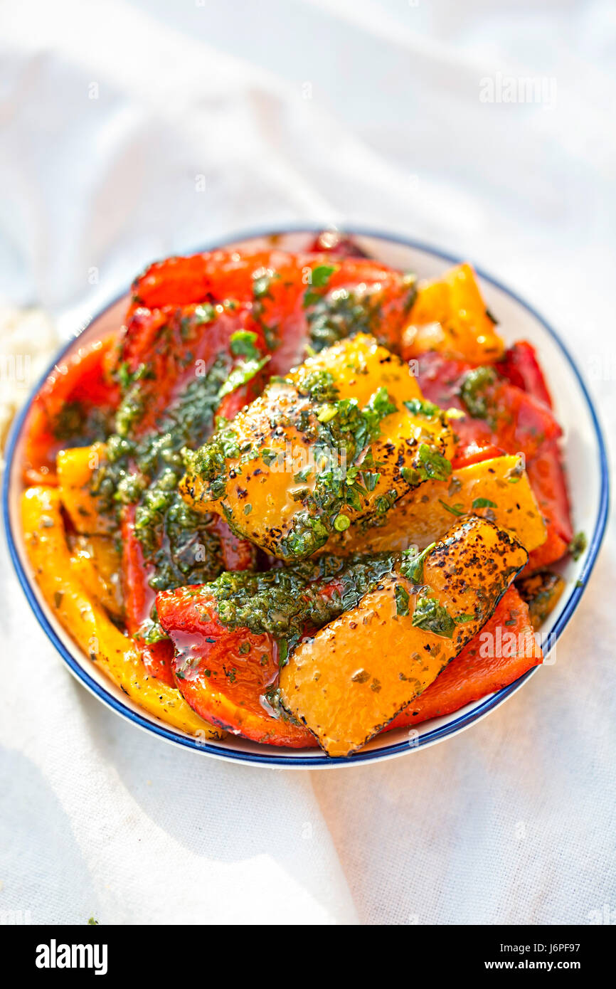 Antipasti - red, green and red peppers with green pesto Stock Photo