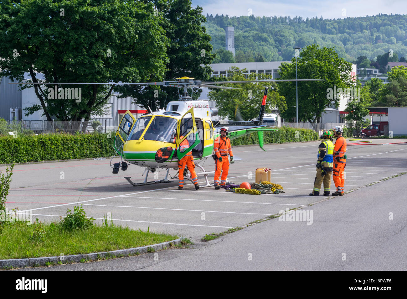 Aérospatiale/Eurocopter AS350 B3 'Écureuil' (Airbus Helicopters H125) on a parking lot, being prepared by personnel for underslung cargo transport. Stock Photo