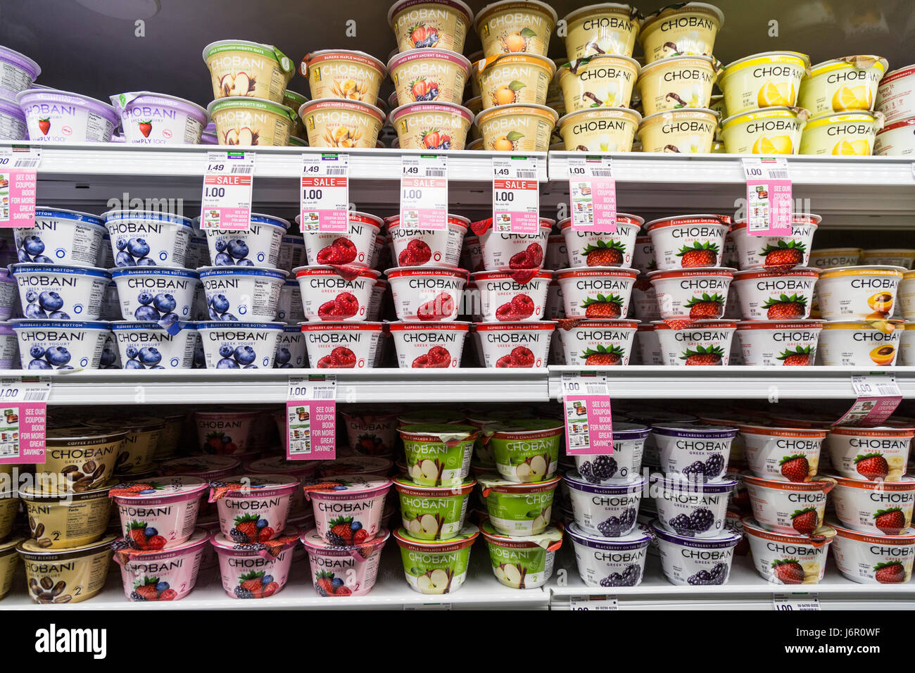 packages of Chobani brand yogurt on the shelves of a refrigerator case