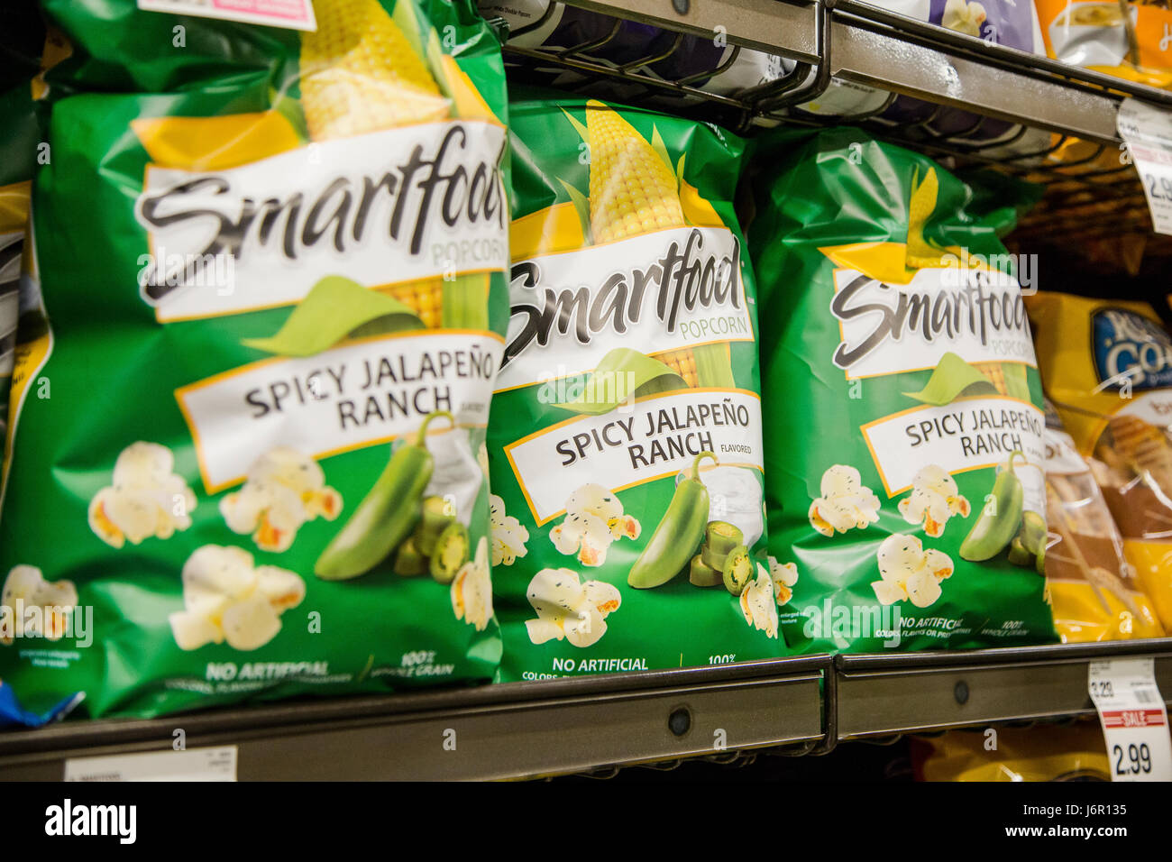 grocery store shelves with bags of Smartfood popcorn on display Stock
