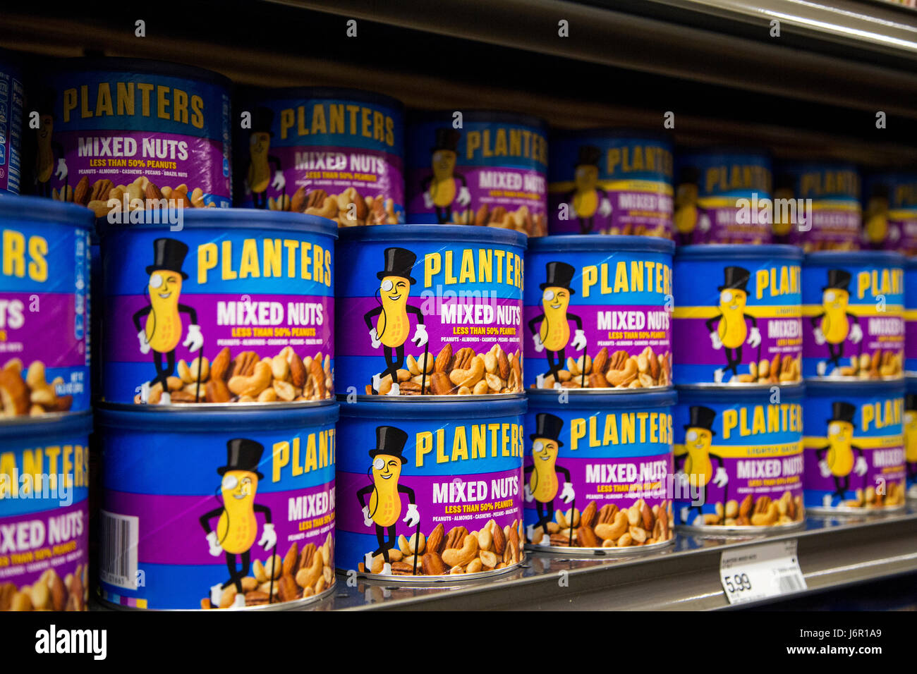 Stacks of Planter mixed nuts canisters staked on a grocery store shelf