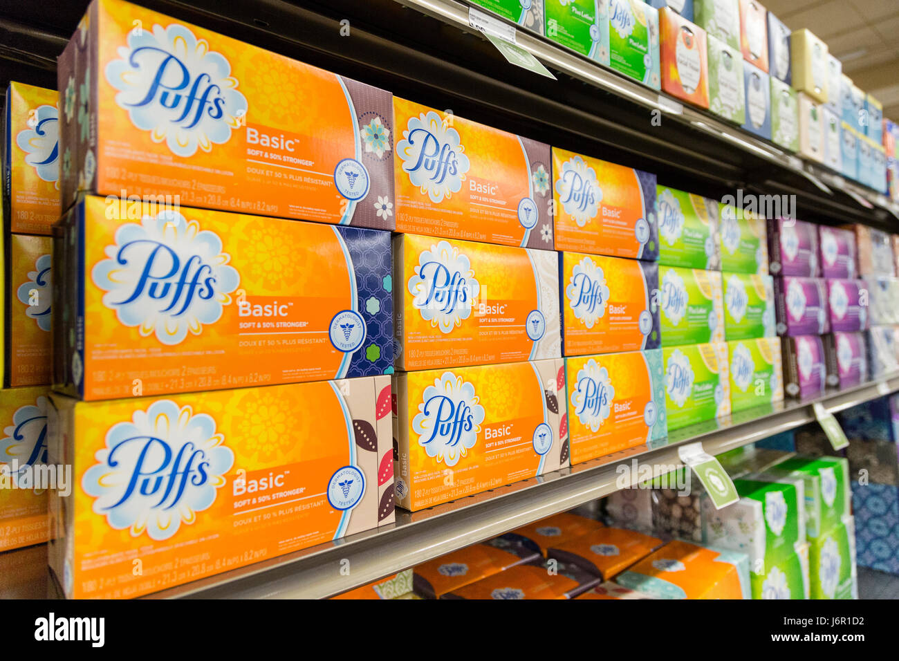 boxes of Puffs brand tissues stacked on grocery store shelves Stock Photo