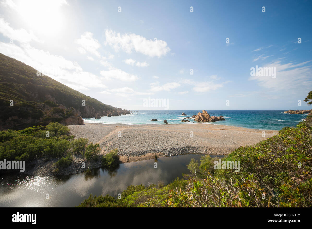 Amazing seascape of a turquoise sea in Italy. Beautiful wild beach of the Emerald coast in Sardinia. Stock Photo