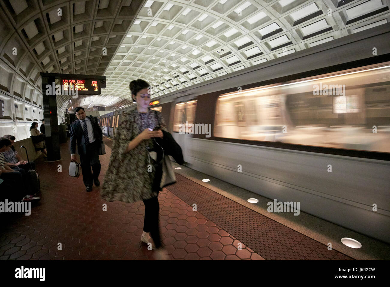 passengers and moving train at smithsonian metro underground train system Washington DC USA deliberate motion blur Stock Photo
