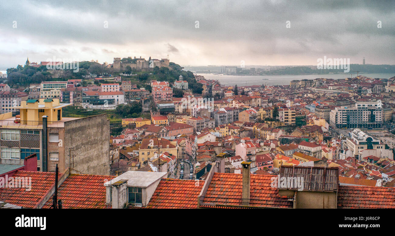 Lisbon is Portugal’s hilly, coastal capital city. From imposing São Jorge Castle, the view encompasses the old city’s pastel-colored buildings, Tagus Estuary and Ponte 25 de Abril suspension bridge. Stock Photo