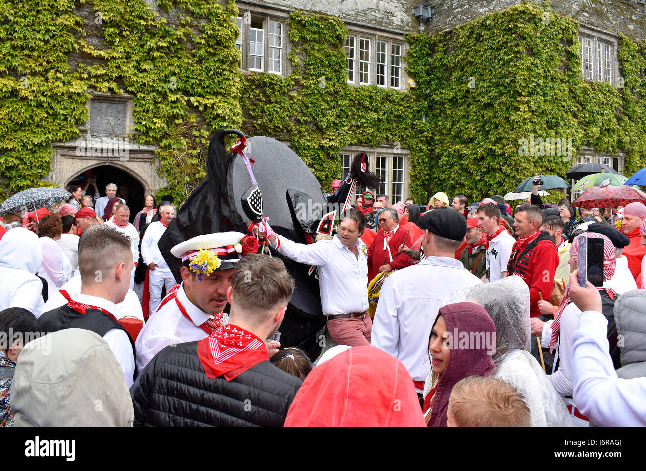Padstow, Cornwall, UK. 1st May 2017, The Red Oss and revellers dance outside Prideaux Place in Padstow during the May Day Obby Oss celebrations. Stock Photo