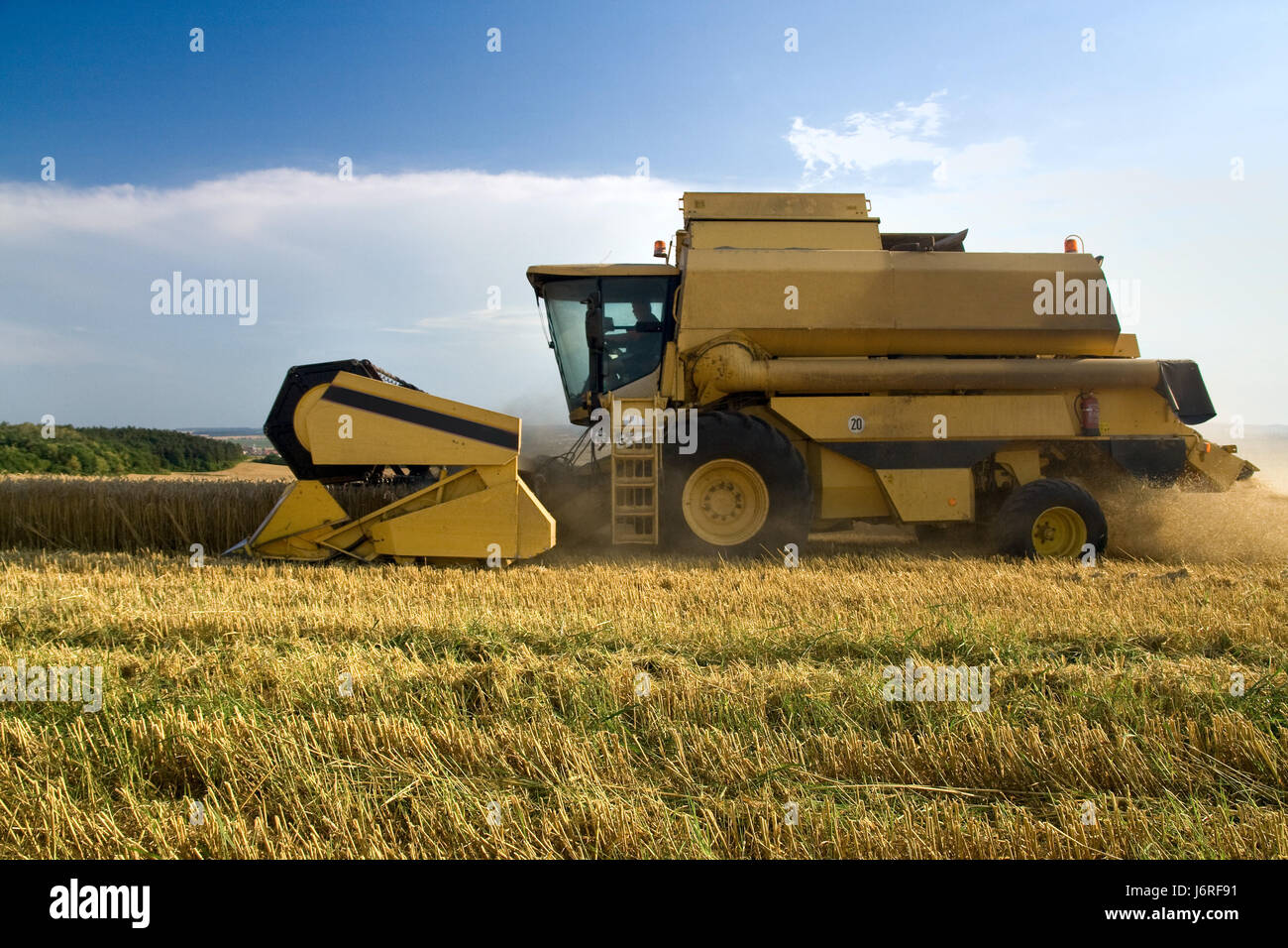 agriculture farming corn cereal harvester harvesting grain combine railway Stock Photo