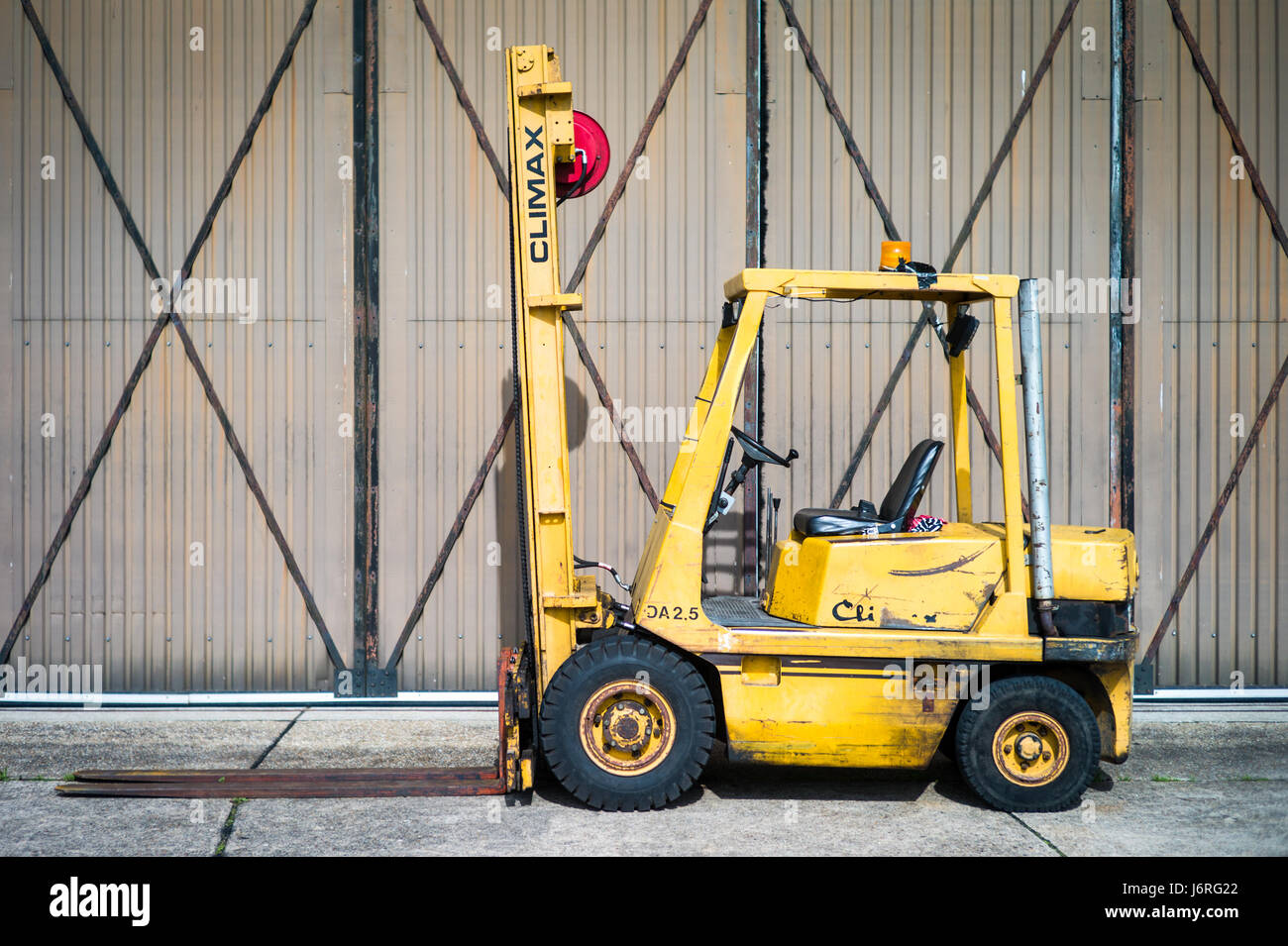Climax Fork Lift Truck outside a warehouse hanger building Stock Photo
