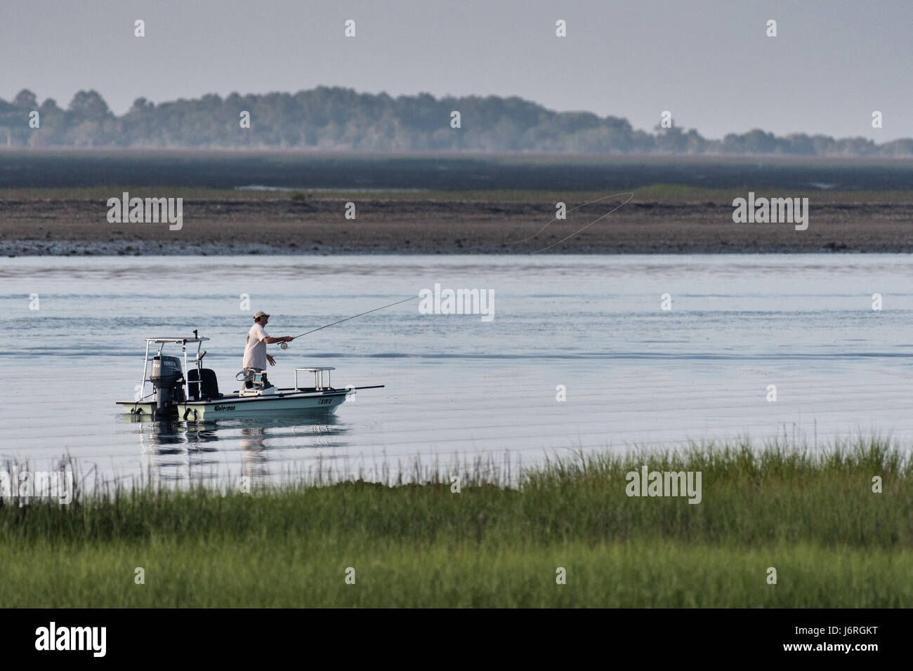 Fly fisherman casting from flats hi-res stock photography and