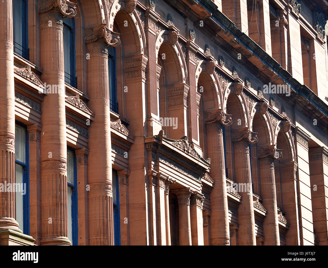 Glasgow Scotland's Victorian Architecture: columns, decorated friezes and lintels from an 1895 red sandstone commercial building Stock Photo