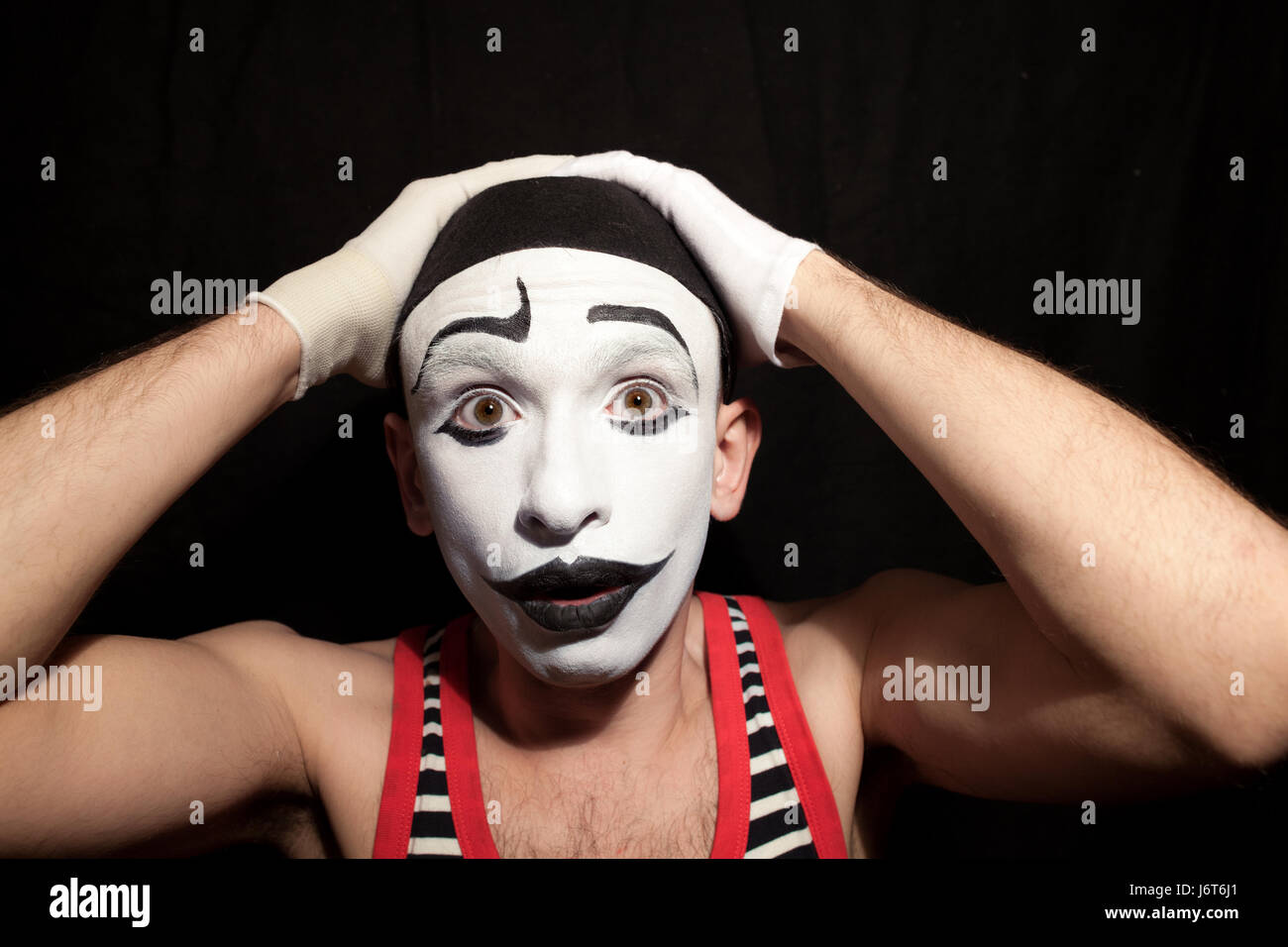 A funny stupid mime grabbed his head Stock Photo