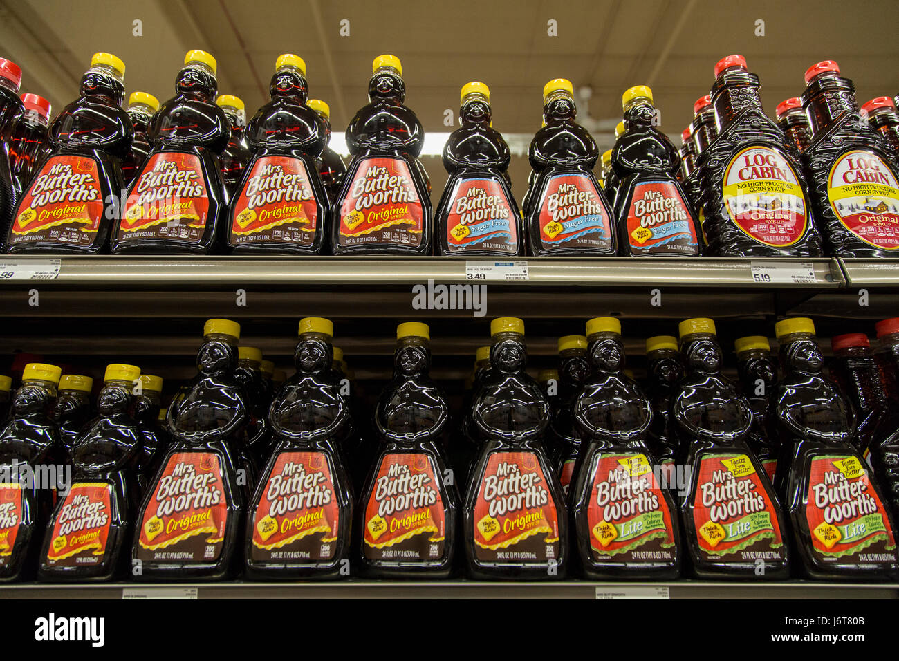 bottles of Mrs. Butterworth's maple syrup on shelves at a grocery store Stock Photo