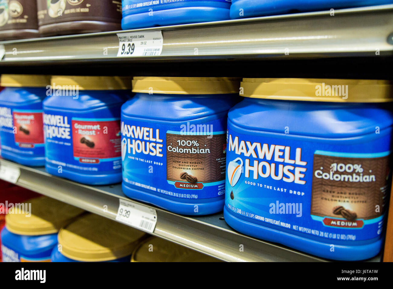 plastic tubs of Maxwell House brand coffee on a grocery store shelf Stock Photo