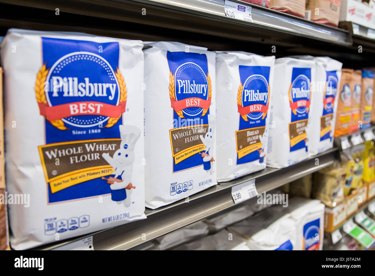 bags of Pillsbury whole wheat flour on the shelf of a grocery store