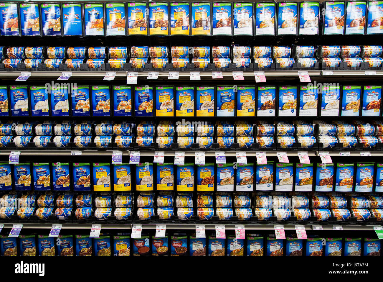 rows of Progresso brand soup cans in a display at a grocery store Stock Photo