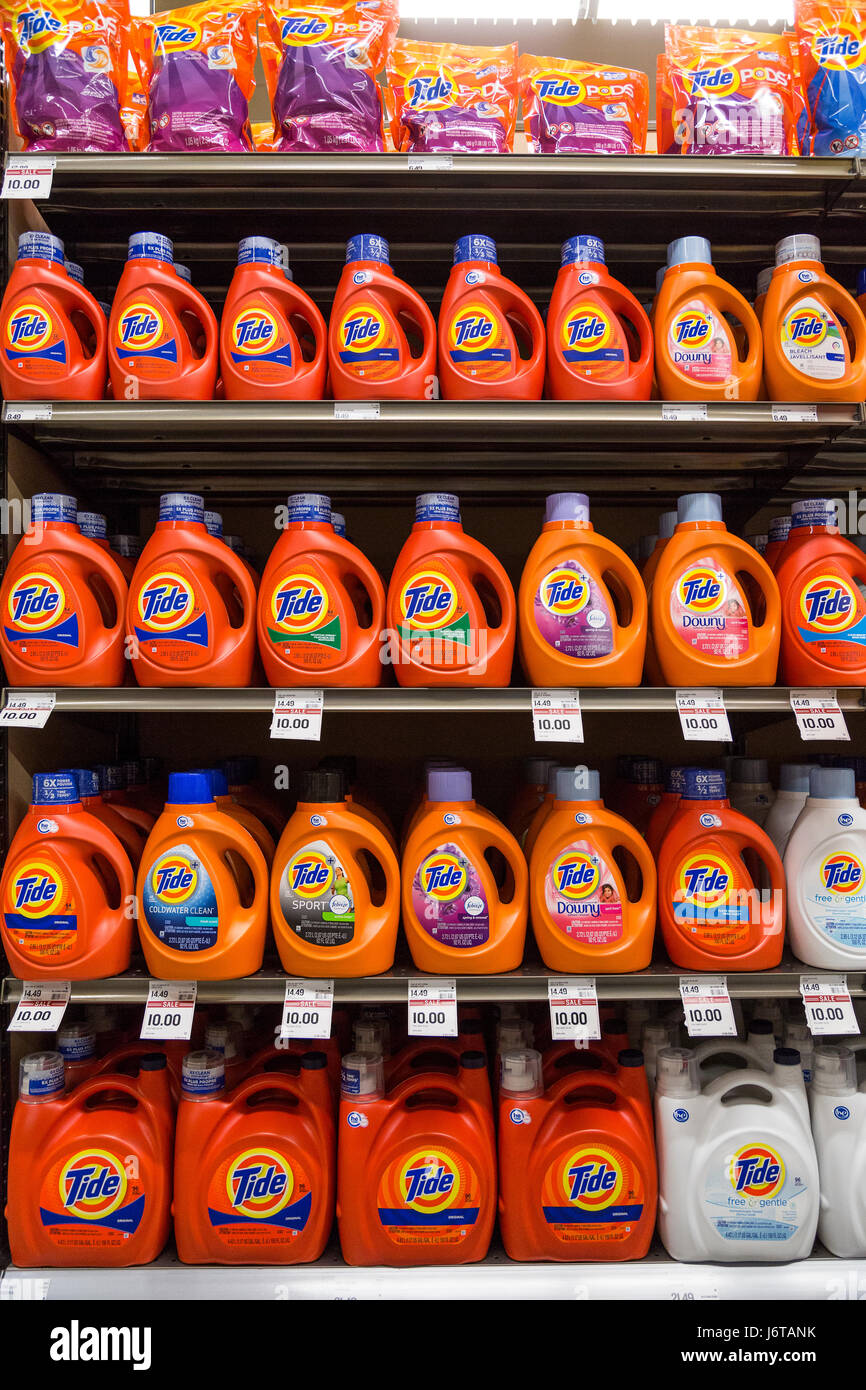 Rows of Tide brand liquid laundry detergent on grocery store shelves