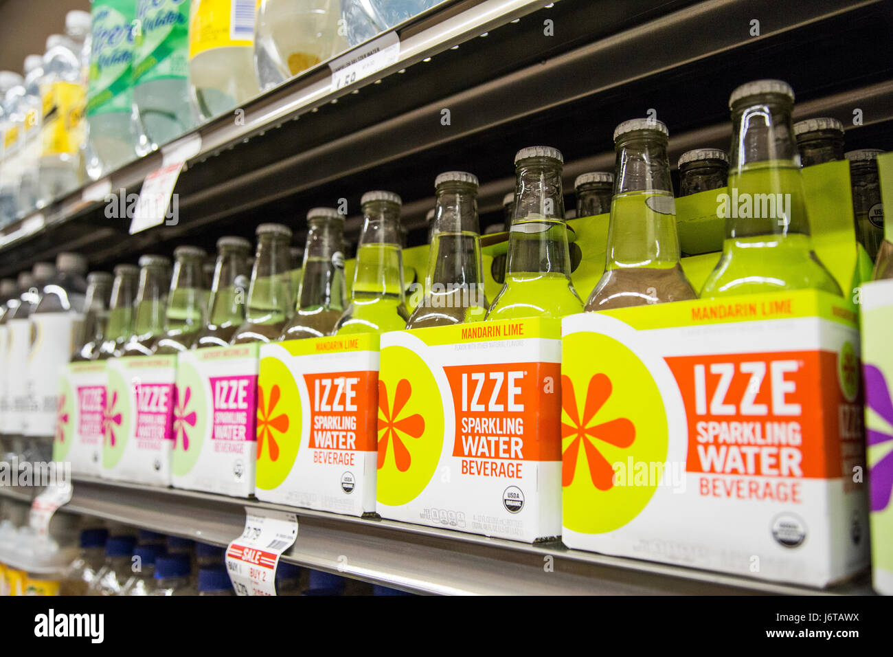 cases of Izze sparkling water on the shelf of a grocery store Stock